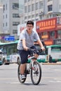 Overweight boy on a mountain bike, Kunming, China